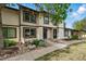 Charming townhouse with neutral siding, a dark front door, and a beautiful rock and garden landscape at 3571 S Kittredge St # C, Aurora, CO 80013