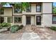 Charming townhouse with neutral siding, a dark front door, and a beautiful rock and garden landscape at 3571 S Kittredge St # C, Aurora, CO 80013