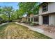 Well-maintained townhome exterior with lush green lawn and walkway at 3571 S Kittredge St # C, Aurora, CO 80013