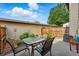 A fenced patio features a glass table with four chairs great for enjoying the outdoor at 3571 S Kittredge St # C, Aurora, CO 80013