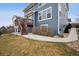 Spacious backyard with lush lawn, concrete walkway, and a charming two-story home with outdoor deck at 2015 E 167Th Ln, Thornton, CO 80602