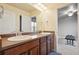 Bathroom featuring dual sinks, vanity with ample counter space, and a large mirror at 2015 E 167Th Ln, Thornton, CO 80602