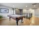 Well-lit game room featuring a pool table and hardwood floors with stair access at 2015 E 167Th Ln, Thornton, CO 80602