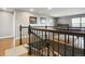 Upstairs game room featuring a stylish staircase, wrought iron railing and hardwood floors at 2015 E 167Th Ln, Thornton, CO 80602