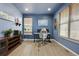 Well-lit home office with blue walls, wood floor, and a large window at 2015 E 167Th Ln, Thornton, CO 80602