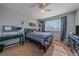 Bedroom with ceiling fan, a window with blinds, desk, and plaid bedding at 10421 Kennemere Ln, Parker, CO 80134