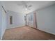 Light-filled bedroom features neutral walls, carpeting, and a ceiling fan at 10421 Kennemere Ln, Parker, CO 80134