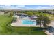 Stunning aerial view of a community pool featuring multiple pools, lounge areas, and green spaces at 10421 Kennemere Ln, Parker, CO 80134