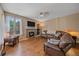 Comfortable living room with fireplace, built-in shelving, and a large leather sectional sofa at 10421 Kennemere Ln, Parker, CO 80134