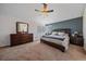 Relaxing main bedroom features a large bed, dresser, and calming blue accent wall at 10421 Kennemere Ln, Parker, CO 80134