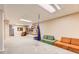 Spacious basement featuring carpeted floors, built-in shelving, and recessed lighting at 6661 Lamar St, Arvada, CO 80003