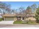 Charming brick home featuring a well-maintained yard and an attached two-car garage at 6661 Lamar St, Arvada, CO 80003