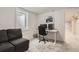 Comfortable home office with gray sofa, desk setup, and a window offering ample natural light at 6661 Lamar St, Arvada, CO 80003