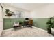Bright home office features stylish desk, chair, printer station, and green accent wall with thriving plants at 6661 Lamar St, Arvada, CO 80003
