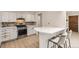 Modern kitchen with stainless steel appliances, quartz countertops, and mosaic backsplash at 6661 Lamar St, Arvada, CO 80003