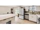 Bright kitchen featuring stainless steel appliances and plenty of countertop space for cooking at 6661 Lamar St, Arvada, CO 80003
