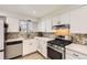 Well-appointed kitchen featuring modern appliances and stylish backsplash, offering a delightful cooking space at 6661 Lamar St, Arvada, CO 80003