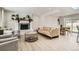 Comfortable living room showcases a cozy fireplace and seamless access to the dining area at 6661 Lamar St, Arvada, CO 80003