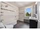 Bathroom with tiled shower/tub, updated vanity, tile floors, and bright window at 1057 N Emerson St # B, Denver, CO 80218