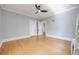 Bright bedroom with hardwood floors, ceiling fan, and large windows at 1057 N Emerson St # B, Denver, CO 80218