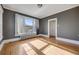 Bedroom with hardwood floors, radiator, gray accent wall, and large window at 1057 N Emerson St # B, Denver, CO 80218