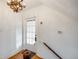 Bright entryway showcasing a white door, hardwood floors, and a decorative chandelier at 1057 N Emerson St # B, Denver, CO 80218