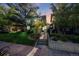 Inviting home featuring a well-maintained lawn, mature trees, and a charming walkway leading to the front door at 1057 N Emerson St # B, Denver, CO 80218