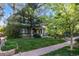 Lovely home featuring lush greenery, a well-kept lawn, and mature trees creating a serene and inviting atmosphere at 1057 N Emerson St # B, Denver, CO 80218
