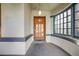 A cozy front porch showcasing a charming wooden door and a curved window, inviting guests into the home at 1057 N Emerson St # B, Denver, CO 80218