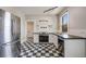 Charming kitchen with stainless steel appliances, black countertops, and checkered floors at 1057 N Emerson St # B, Denver, CO 80218