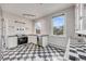 Bright kitchen featuring black and white checkered floors, stainless steel appliances, and ample natural light at 1057 N Emerson St # B, Denver, CO 80218
