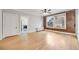 Spacious living room boasting wood floors, exposed brick, large windows, and an open doorway to the kitchen at 1057 N Emerson St # B, Denver, CO 80218