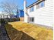 Backyard with new sod and a home with white siding and black trim at 11304 Elm Dr, Thornton, CO 80233