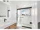 Modern bathroom featuring a glass enclosed shower, updated vanity, and black hardware accents at 11304 Elm Dr, Thornton, CO 80233