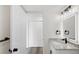 Bathroom with a vanity with granite countertop and illuminated mirror adjacent to closet at 11304 Elm Dr, Thornton, CO 80233