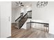 Inviting entryway with modern railing, stylish decor, and hardwood floors at 11304 Elm Dr, Thornton, CO 80233