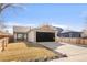 Charming ranch-style home features a black garage door, neutral paint, and a well-manicured front yard at 11304 Elm Dr, Thornton, CO 80233