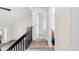 Upstairs hallway with modern railing and adjacent bedroom and bathroom at 11304 Elm Dr, Thornton, CO 80233