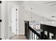 Bright upstairs hallway with modern railing and chandelier at 11304 Elm Dr, Thornton, CO 80233