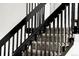Modern staircase with black railings and carpeted steps at 11304 Elm Dr, Thornton, CO 80233