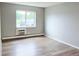 This bedroom features wood floors, neutral paint, and a window with natural light at 9650 Huron St # 3, Thornton, CO 80260
