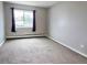 This bedroom features wall-to-wall carpet, neutral paint, and a window with blackout curtains at 9650 Huron St # 3, Thornton, CO 80260
