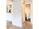 This hallway features white trim, hardwood floors and offers an opening to the kitchen and bathroom at 9650 Huron St # 3, Thornton, CO 80260