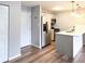 Bright kitchen features stainless steel appliances, island with quartz countertop, and wood flooring at 9650 Huron St # 3, Thornton, CO 80260