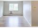 Living room with stylish wood floors, neutral walls, and a bright window at 9650 Huron St # 3, Thornton, CO 80260