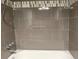 The shower features modern gray tiling and a decorative tile border at 9650 Huron St # 3, Thornton, CO 80260