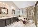 Elegant bathroom showcasing dual sinks, a soaking tub, and a separate glass-enclosed shower at 2238 S Nome Ct, Aurora, CO 80014