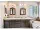 Bright bathroom featuring double sinks, two decorative mirrors and natural light from the window at 2238 S Nome Ct, Aurora, CO 80014