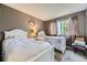 Charming bedroom with two twin beds, soft textures, and a window bringing in natural light at 2238 S Nome Ct, Aurora, CO 80014
