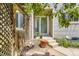 Inviting front entrance featuring a cozy patio area, decorative wood screen, and a welcoming glass door at 2238 S Nome Ct, Aurora, CO 80014